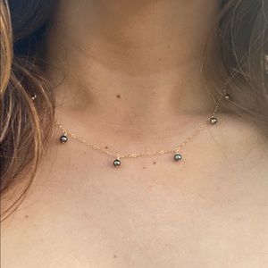 Small Tahitian pearls dangling on a necklace
